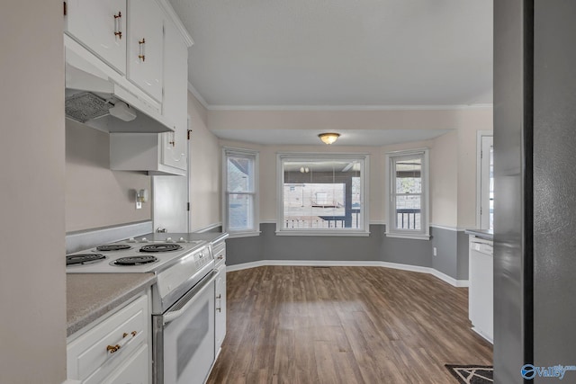 kitchen featuring white appliances, wood-type flooring, ornamental molding, and white cabinets