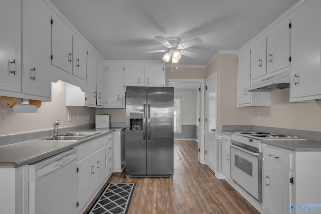 kitchen with dark wood-type flooring, sink, a textured ceiling, white appliances, and white cabinets