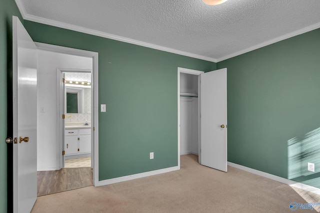 unfurnished bedroom with ornamental molding, light carpet, and a textured ceiling