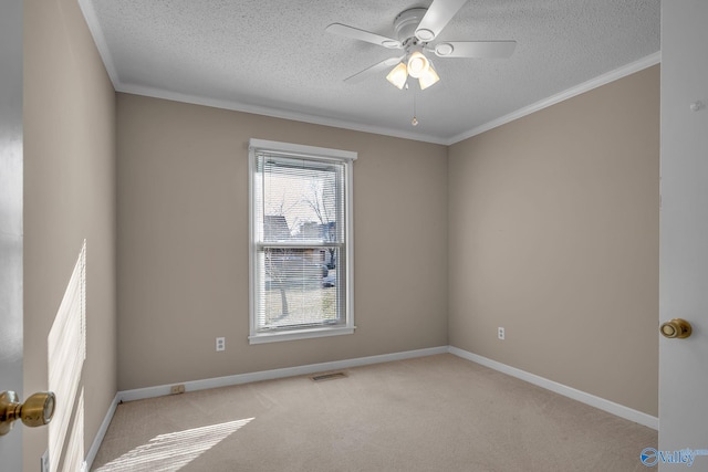 empty room featuring crown molding, light carpet, ceiling fan, and a textured ceiling