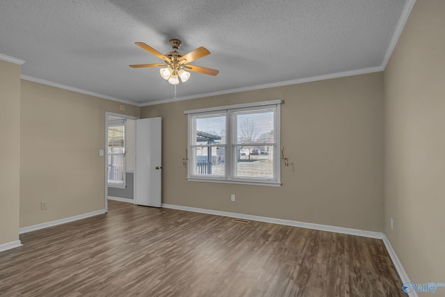 empty room featuring wood-type flooring, ornamental molding, ceiling fan, and a textured ceiling