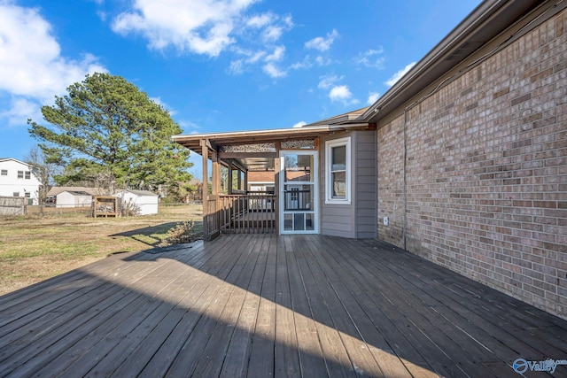 wooden terrace with a lawn