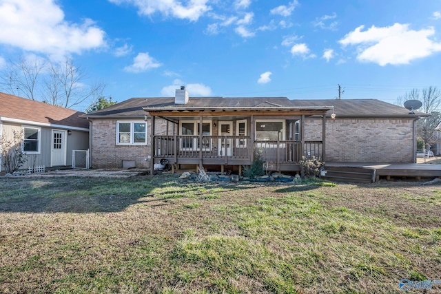 back of house featuring a yard and a deck