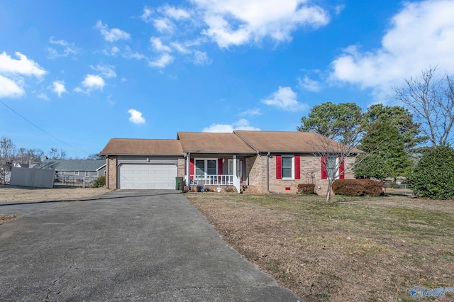 view of front of property with a garage, a porch, and a front lawn