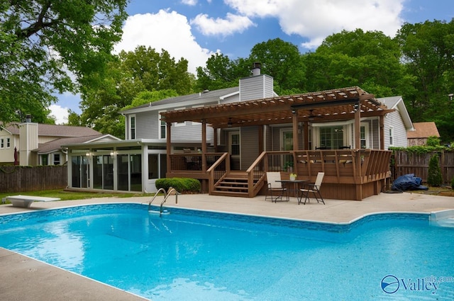 rear view of house featuring a pergola, a sunroom, fence, and a deck