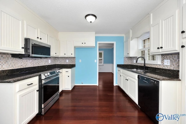 kitchen with a sink, dark wood-style flooring, white cabinetry, crown molding, and appliances with stainless steel finishes