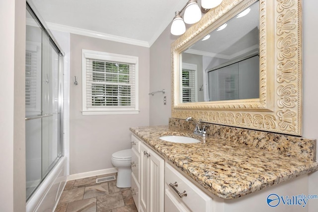 bathroom featuring crown molding, vanity, baseboards, toilet, and stone finish floor