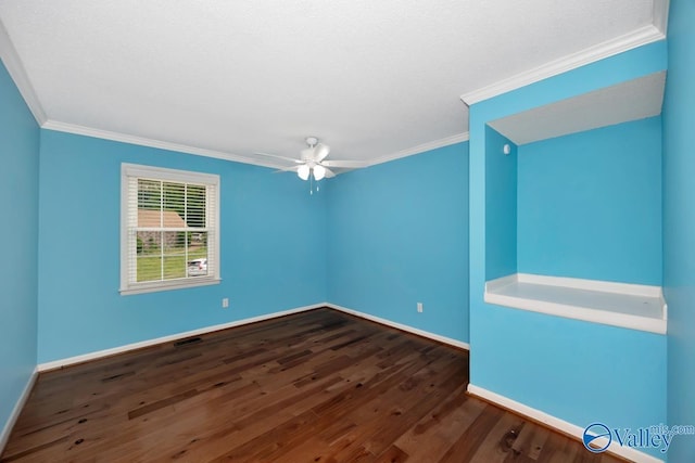spare room featuring baseboards, dark wood-style floors, ceiling fan, and crown molding