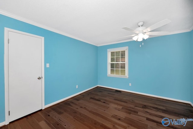 spare room with ornamental molding, hardwood / wood-style flooring, baseboards, and a ceiling fan