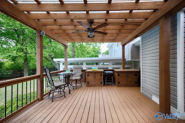 wooden terrace featuring a pergola, a ceiling fan, and fence