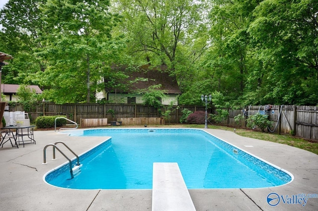 view of pool featuring a fenced backyard, a diving board, a patio area, and a fenced in pool