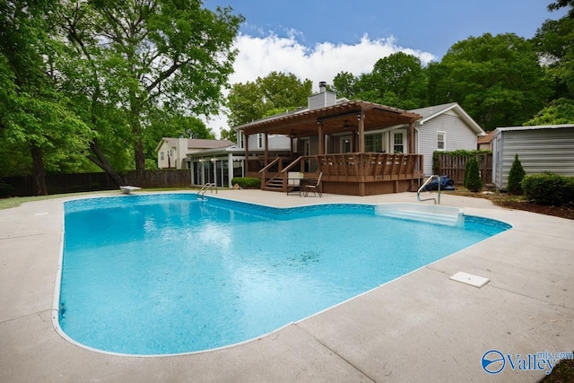 view of pool with a patio area, a deck, a ceiling fan, a fenced backyard, and a fenced in pool