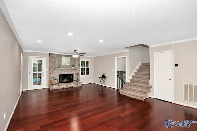 unfurnished living room with stairway, wood finished floors, visible vents, baseboards, and ceiling fan
