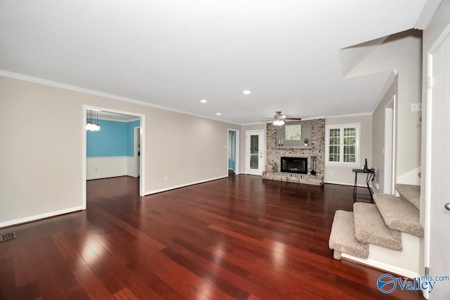 unfurnished living room featuring crown molding, a ceiling fan, stairs, and wood-type flooring