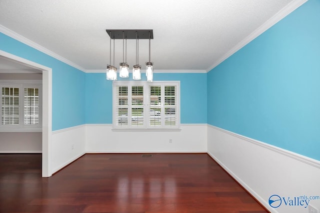 unfurnished dining area featuring wood finished floors, baseboards, and ornamental molding
