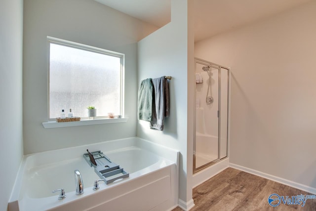 bathroom featuring hardwood / wood-style floors and separate shower and tub