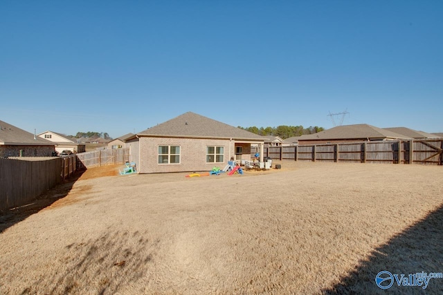 rear view of house featuring a playground