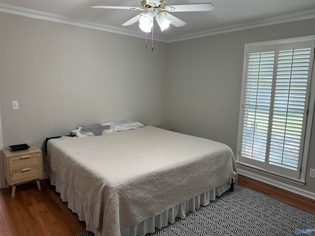 bedroom featuring ceiling fan, crown molding, and dark hardwood / wood-style flooring