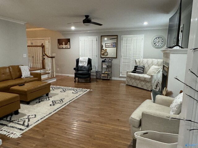 living room featuring ornamental molding, ceiling fan, and hardwood / wood-style floors