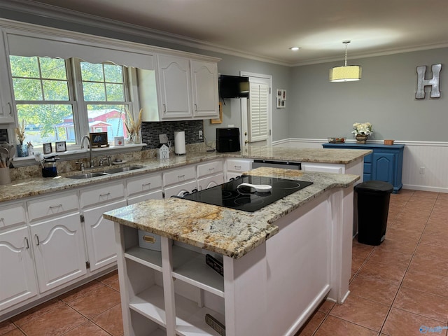 kitchen featuring crown molding, a kitchen island, pendant lighting, and white cabinetry