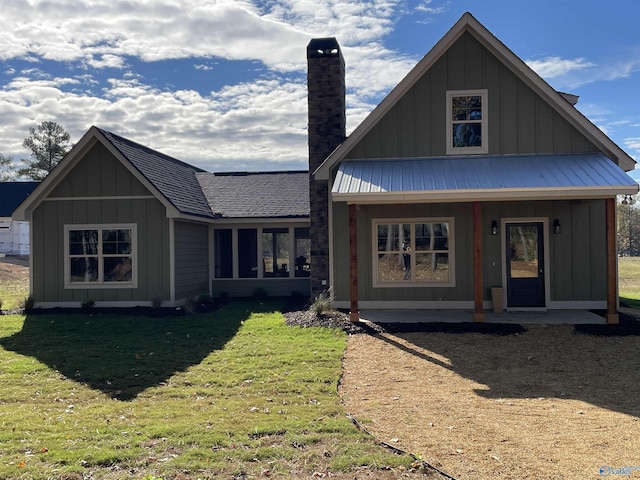 view of front of property with a front yard and covered porch