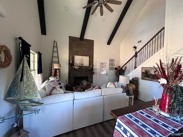 living room with a stone fireplace, high vaulted ceiling, beamed ceiling, dark hardwood / wood-style flooring, and ceiling fan