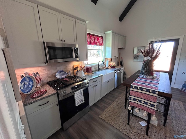 kitchen featuring white cabinetry, sink, decorative backsplash, and stainless steel appliances