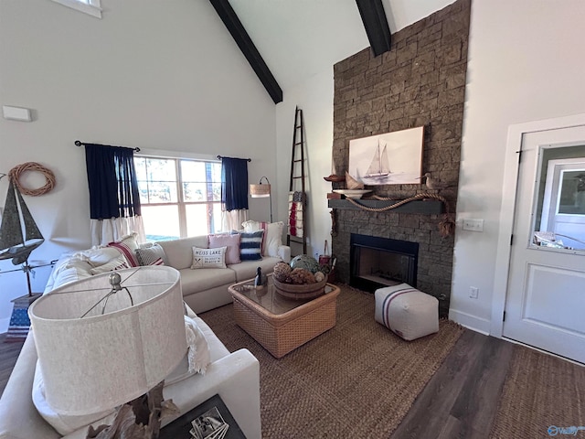 living room with beamed ceiling, dark hardwood / wood-style floors, high vaulted ceiling, and a stone fireplace