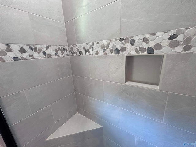 bathroom with tiled shower