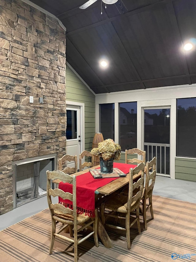 wooden deck featuring ceiling fan and an outdoor stone fireplace