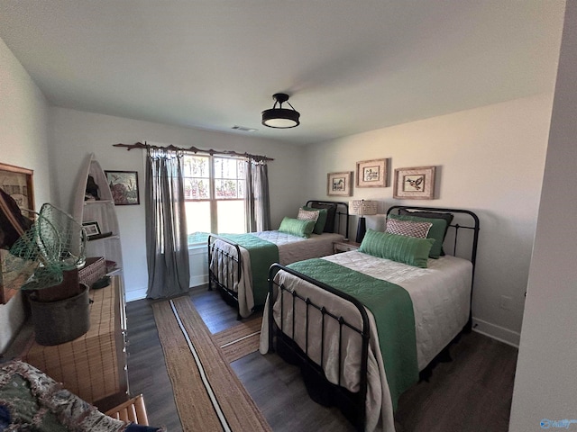 bedroom with dark wood-type flooring