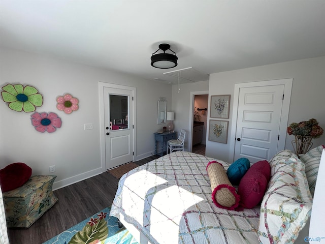 bedroom with dark hardwood / wood-style flooring and connected bathroom