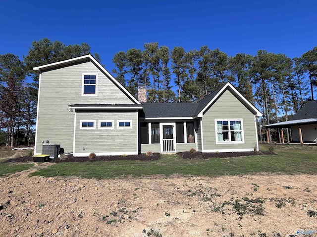 view of front of property featuring central AC and a front lawn