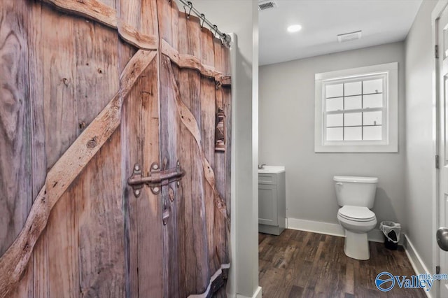 2403 Hog Jaw Rd, Arab, AL 35016 - bathroom featuring visible vents, toilet, wood finished floors, baseboards, and vanity