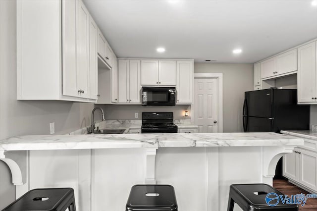 2403 Hog Jaw Rd, Arab, AL 35016 - kitchen featuring a sink, black appliances, a peninsula, and white cabinetry