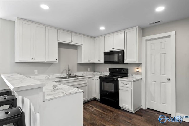 2403 Hog Jaw Rd, Arab, AL 35016 - kitchen featuring visible vents, black appliances, a peninsula, white cabinetry, and a sink