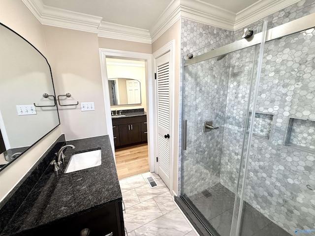 full bath featuring ornamental molding, a stall shower, visible vents, and vanity