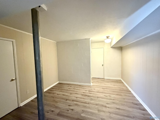 finished basement featuring baseboards and wood finished floors