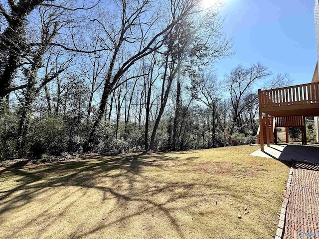 view of yard featuring a patio, a wooden deck, and stairs