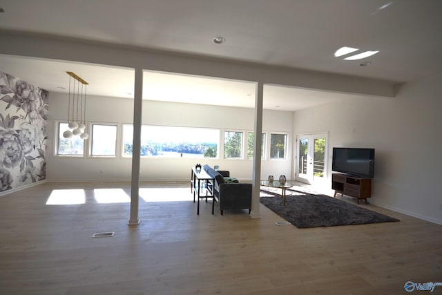 living room featuring beamed ceiling and wood-type flooring