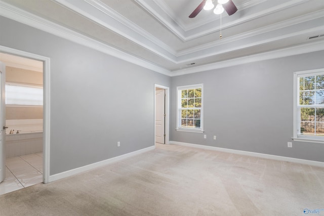 unfurnished room featuring light colored carpet, ceiling fan, crown molding, and a tray ceiling