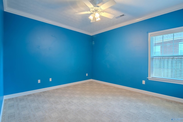 carpeted spare room with ceiling fan and ornamental molding