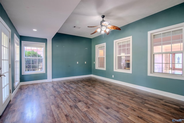 unfurnished room with ceiling fan, dark hardwood / wood-style flooring, and french doors