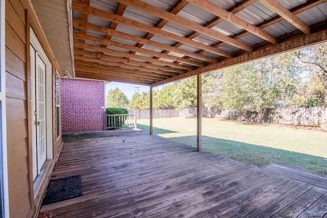 wooden terrace featuring a lawn