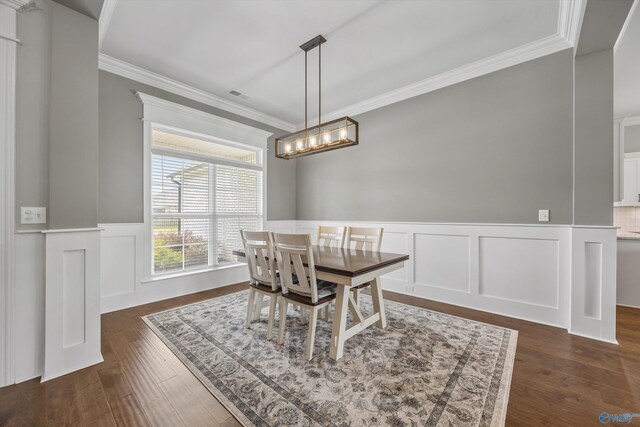 106 Timber Springs Ct, Madison, AL 35756 - dining space featuring ornamental molding, wainscoting, a chandelier, a decorative wall, and dark wood-style flooring