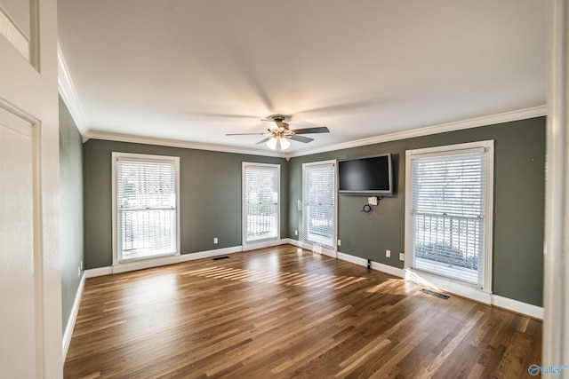 spare room with ceiling fan, crown molding, and a wealth of natural light