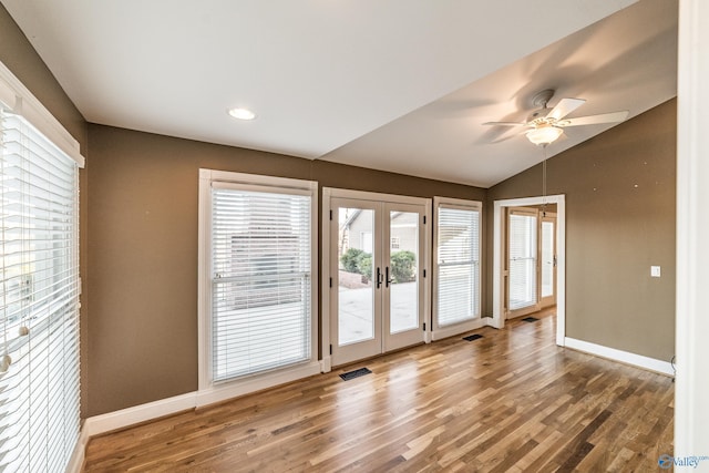 spare room with ceiling fan, wood-type flooring, lofted ceiling, and french doors