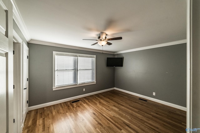 unfurnished bedroom featuring dark hardwood / wood-style flooring, ceiling fan, and ornamental molding