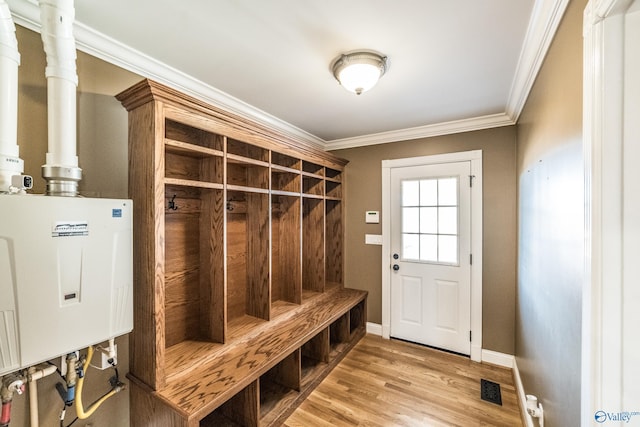 mudroom featuring tankless water heater, ornamental molding, and light hardwood / wood-style flooring