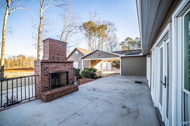 view of patio featuring an outdoor brick fireplace